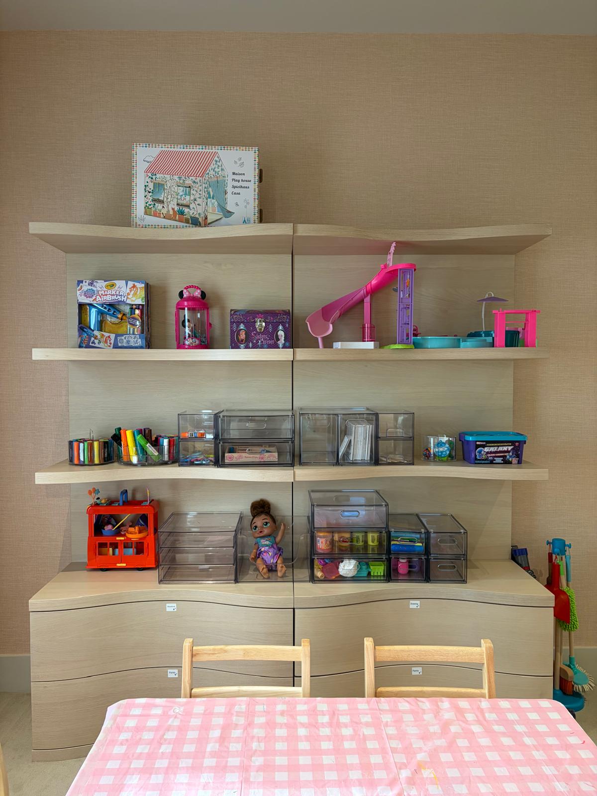 Child's room with organized toy shelves and labeled bins